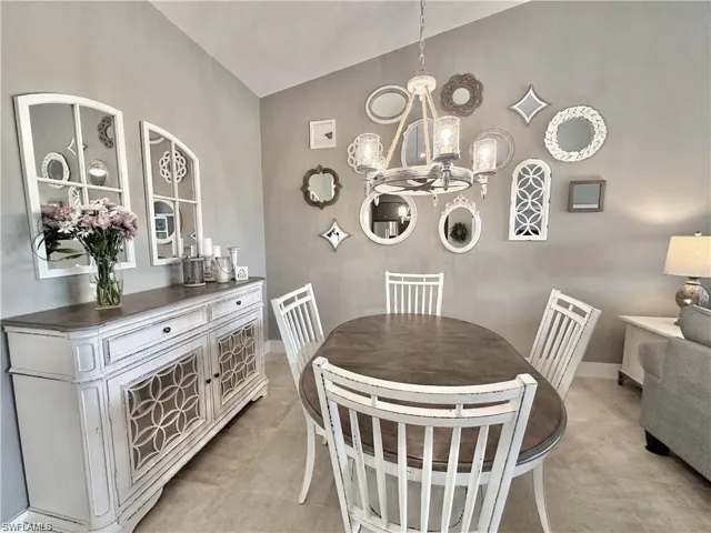 Dining space with a chandelier and vaulted ceiling