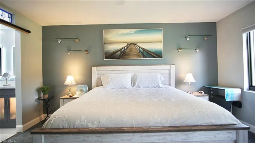Bedroom with ceiling fan and ensuite bath
