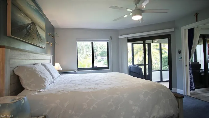 Bedroom with carpet, ceiling fan, and access to exterior
