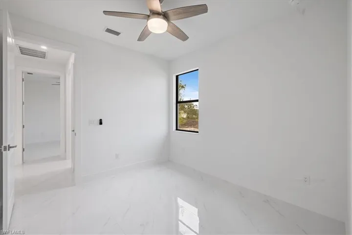 Unfurnished room featuring ceiling fan