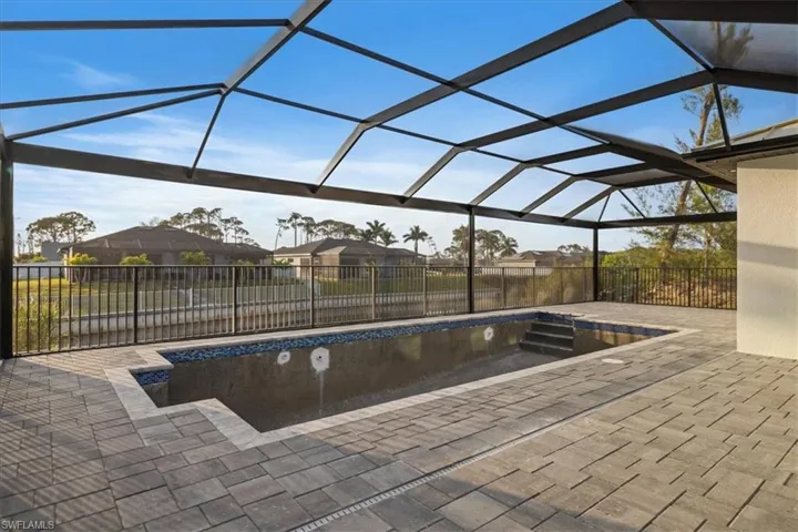 View of swimming pool with a patio and glass enclosure