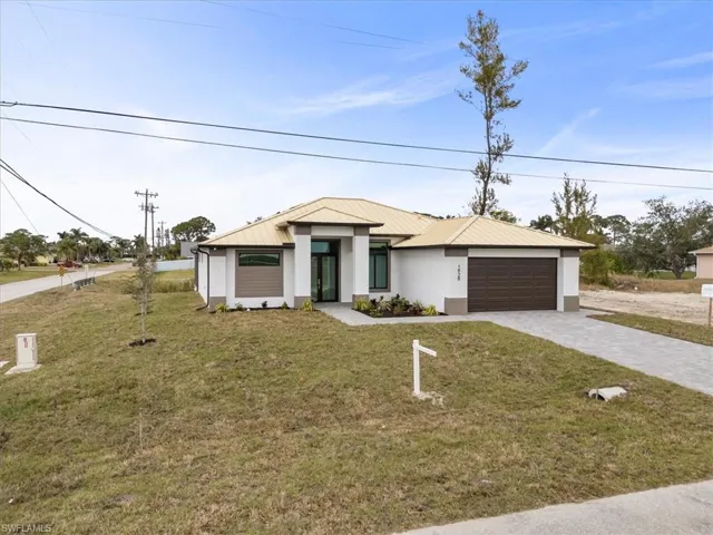 View of front of home with a garage and a front yard