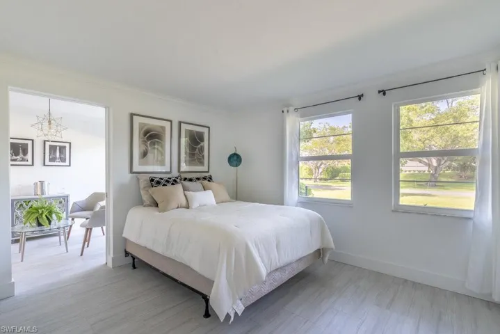 Bedroom featuring ornamental molding and light wood finished floors