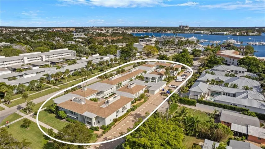 Aerial perspective of suburban area featuring a nearby body of water
