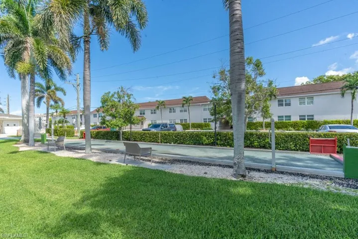 View of property's community with a lawn
