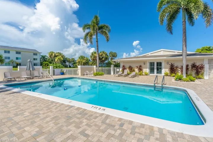 Community pool featuring french doors and a patio