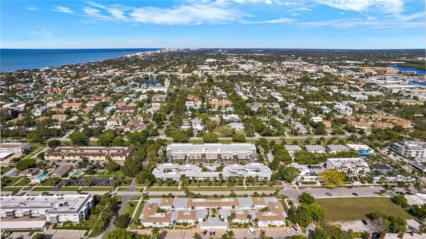 View of property location featuring a nearby body of water and nearby suburban area