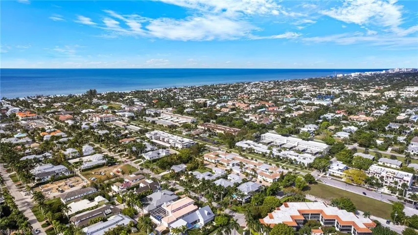 Aerial view of property's location with a large body of water and nearby suburban area