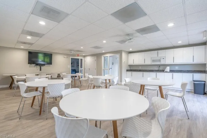 Dining area featuring ceiling fan, a paneled ceiling, light wood finished floors, and recessed lighting