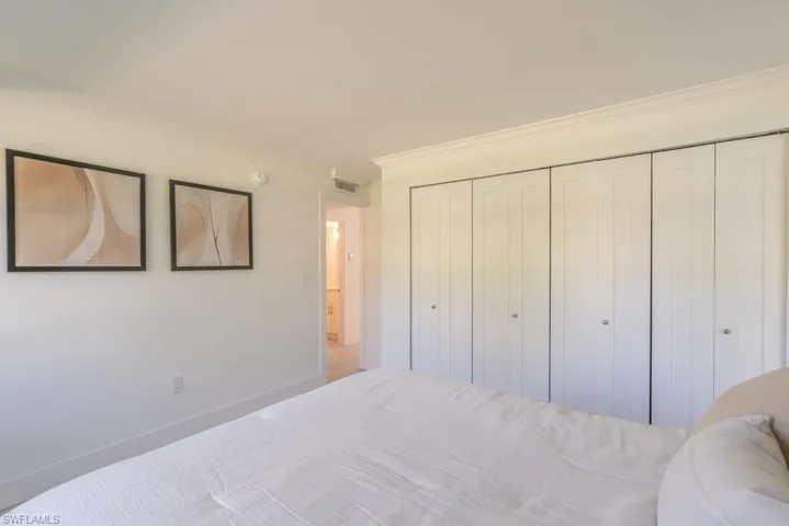 Bedroom with a closet and crown molding
