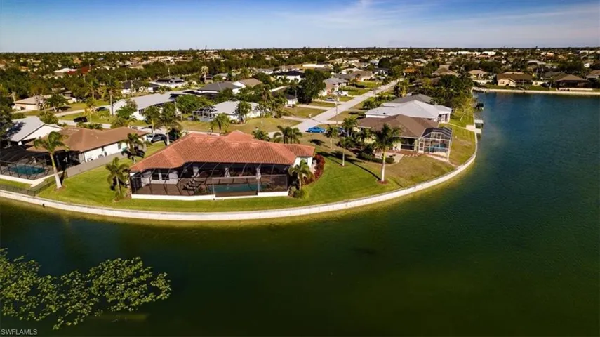 Birds eye view of property with a water view