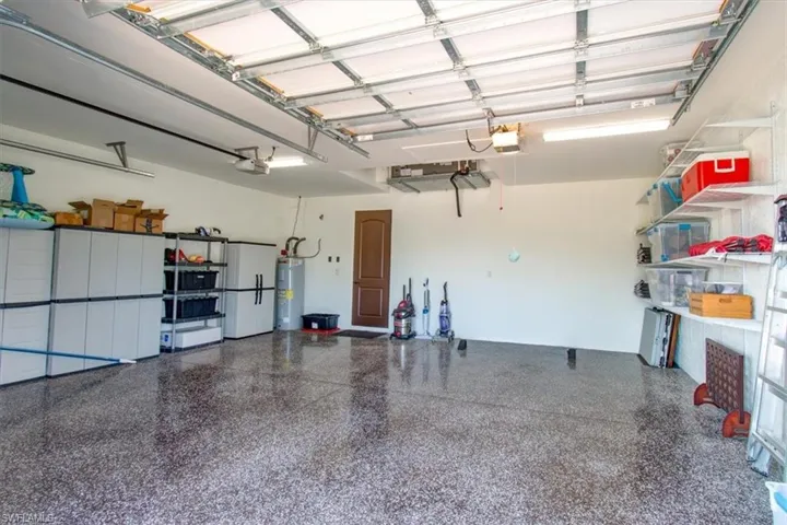 Garage with electric water heater and a garage door opener