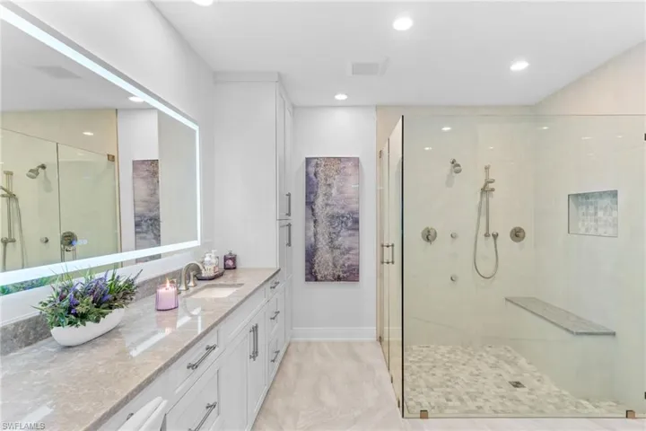Bathroom with vanity, a stall shower, and recessed lighting