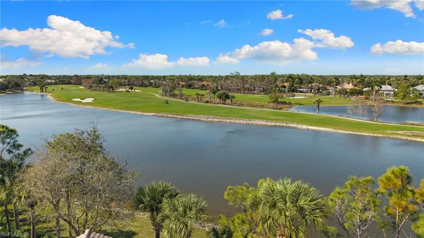 Water view featuring a local golf course and a tree filled landscape