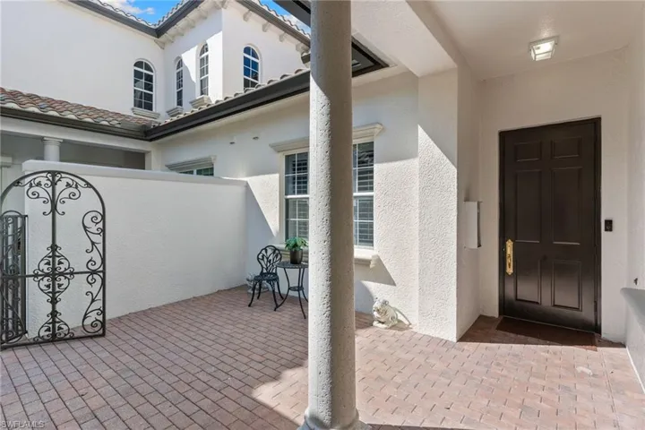 Doorway to property featuring a patio area and stucco siding