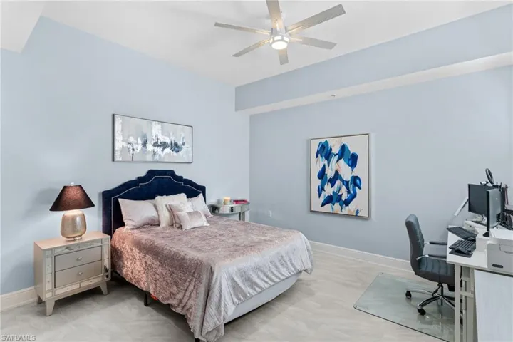 Bedroom with an office area and ceiling fan