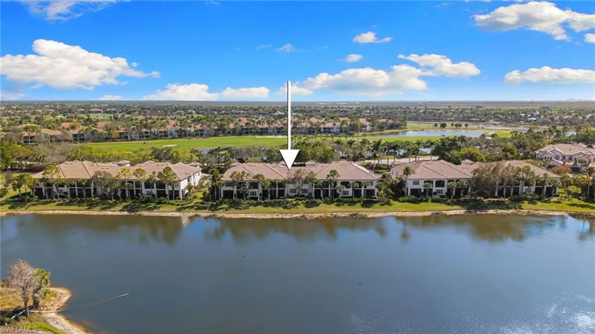 Aerial perspective of suburban area featuring a large body of water and a golf club