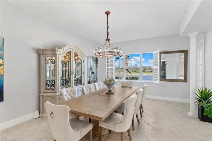 Dining space with suspended lighting and light tile patterned floors