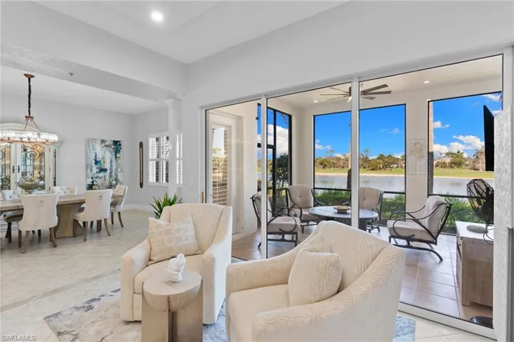 Living area featuring suspended lighting, a water view, and a ceiling fan