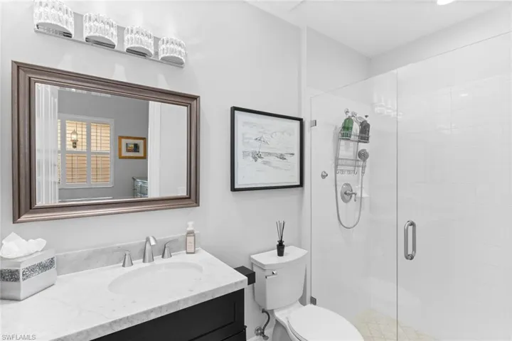 Bathroom featuring vanity and a stall shower