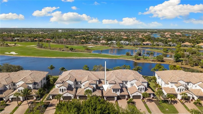 Aerial perspective of suburban area featuring a nearby body of water and a golf club