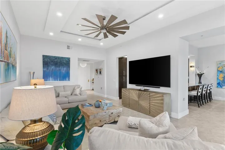 Living area featuring ceiling fan and recessed lighting