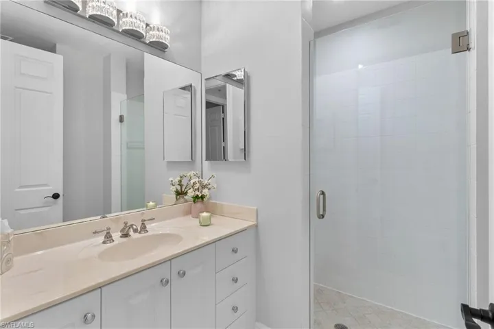 Full bath featuring vanity and a stall shower