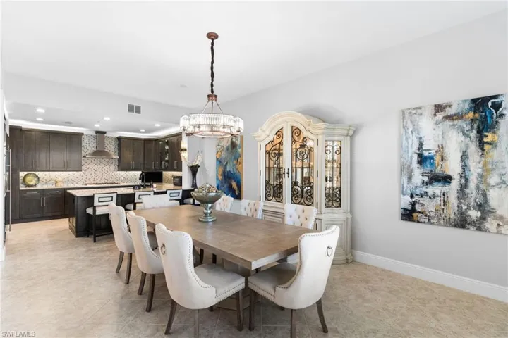 Dining space featuring baseboards and a chandelier