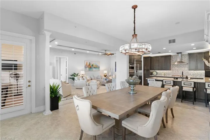 Dining space featuring ceiling fan, hanging lights, and light tile patterned flooring