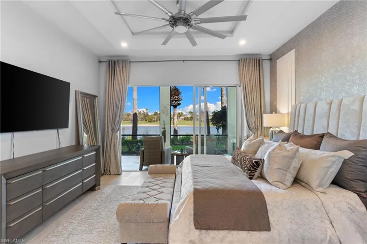 Bedroom featuring a water view, access to outside, ceiling fan, and recessed lighting