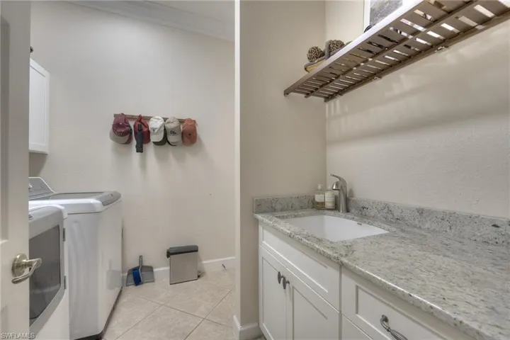 Laundry between kitchen and garage upgraded with granite counter and newer w/d.