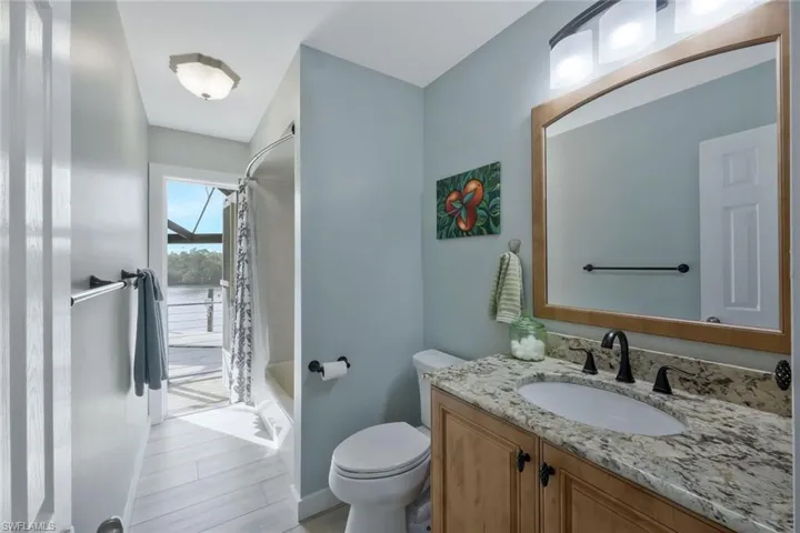3rd bathroom offers access to your pool, a grantite countertop single vanity, shower/tub combination.
