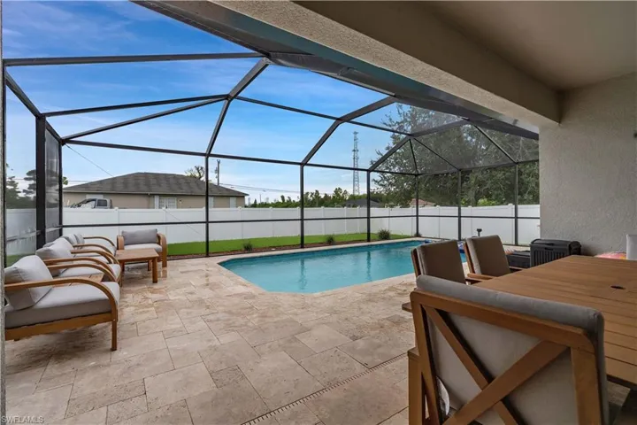 View of pool with a sunroom, a fenced backyard, a patio, and a lanai