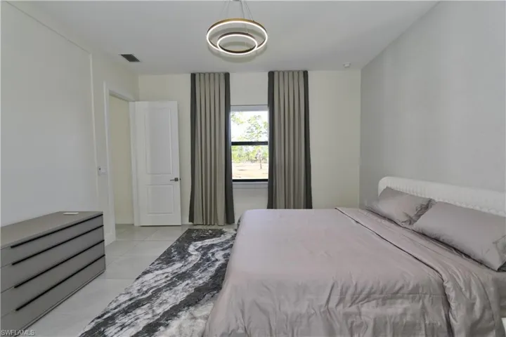 Bedroom with light tile patterned floors