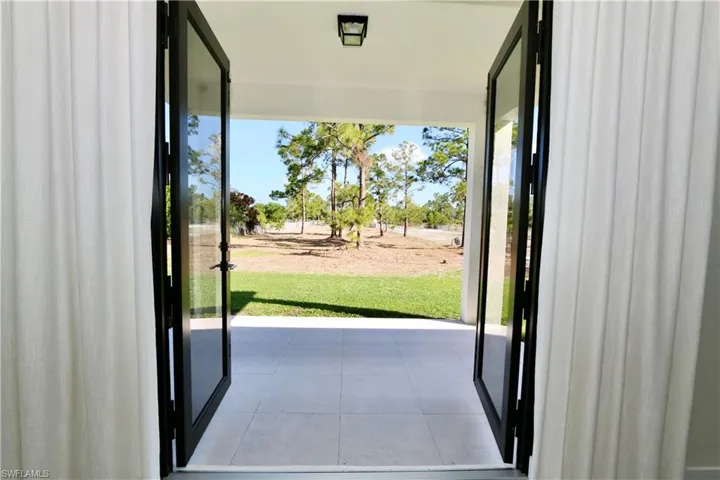 Doorway featuring tile patterned flooring