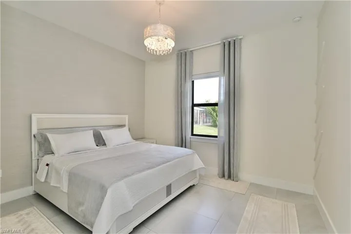 Bedroom featuring baseboards and hanging lights