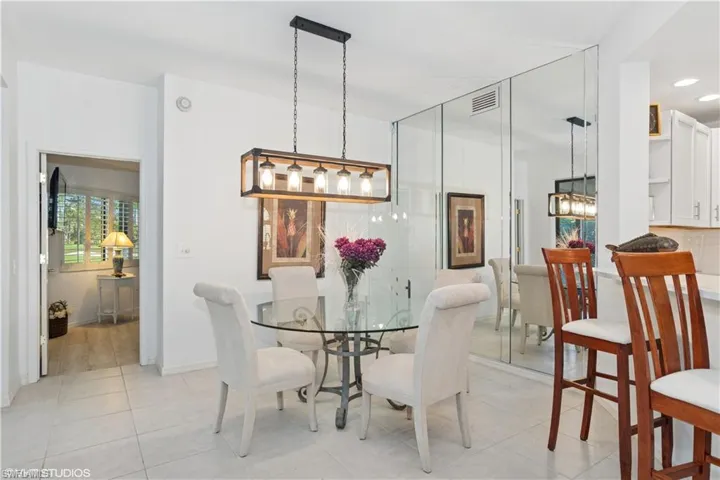 Dining room with light tile patterned floors, baseboards, visible vents, and recessed lighting