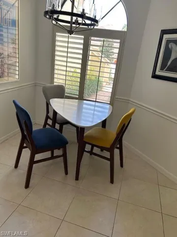 Dining room featuring a chandelier and light tile patterned floors