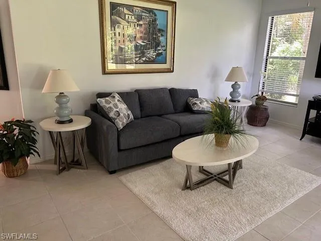 Living area featuring light tile patterned flooring and baseboards