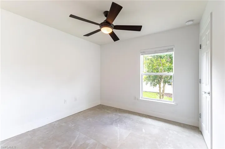 Unfurnished room featuring baseboards and a ceiling fan