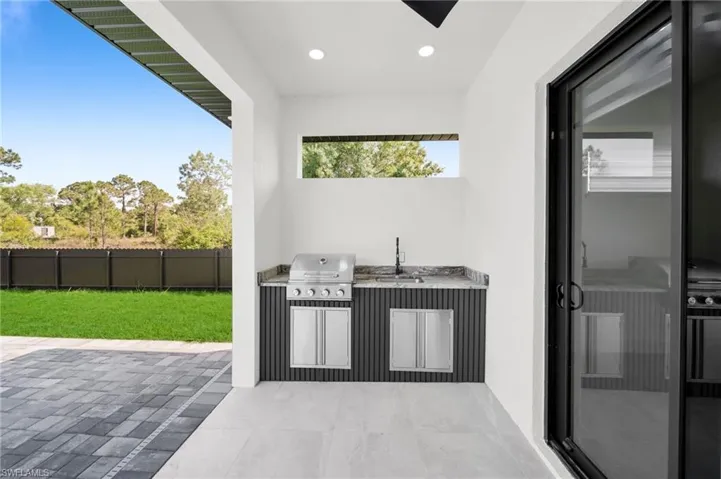 View of patio / terrace featuring grilling area, area for grilling, a sink, and fence