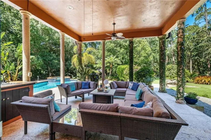 View of patio / terrace with outdoor lounge area, a pool with connected hot tub, and ceiling fan