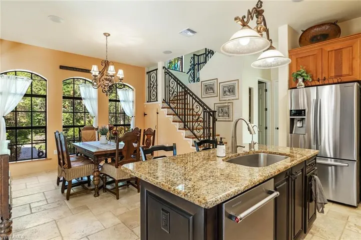 Kitchen featuring a sink, visible vents, stone tile flooring, and appliances with stainless steel finishes