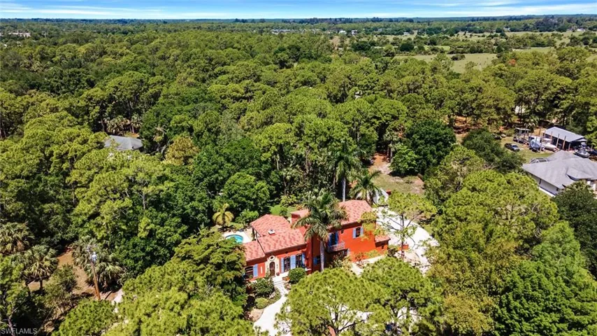 Aerial view featuring a view of trees