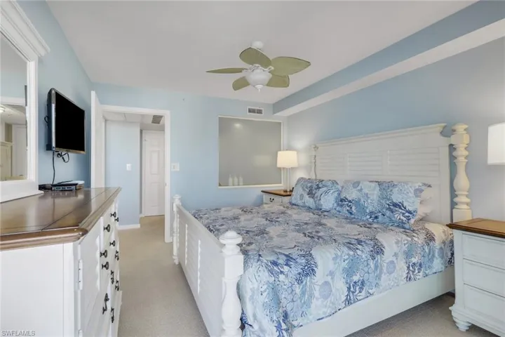 Bedroom with light carpet and a ceiling fan