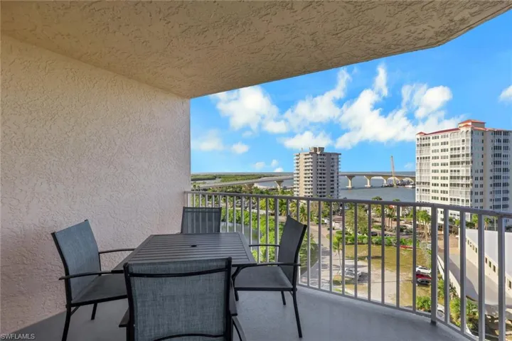 Balcony with a water view and outdoor dining area