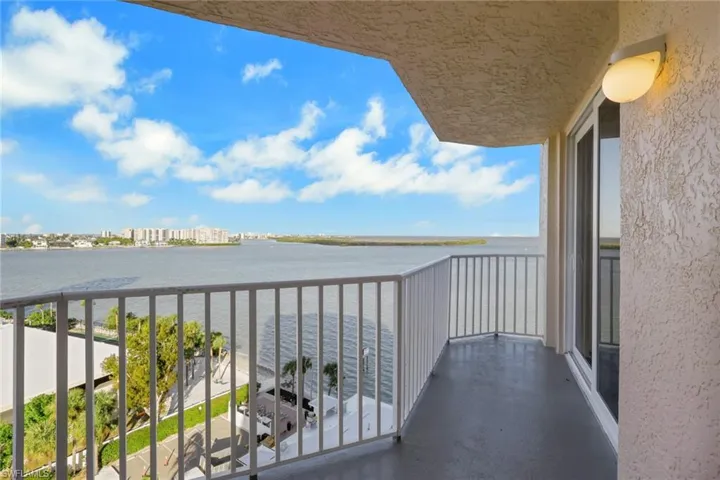 Balcony with a water view and a city view