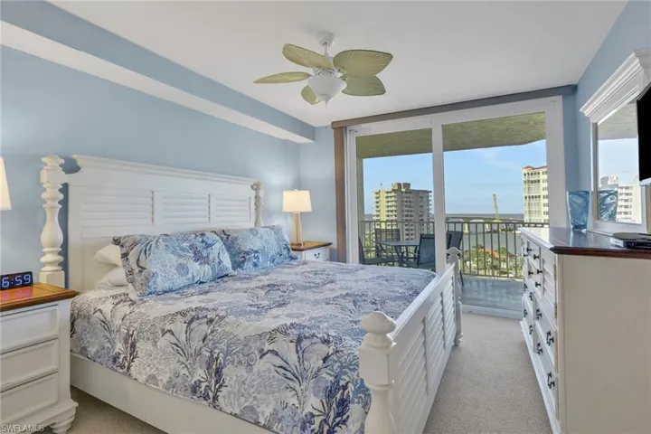 Bedroom with light carpet, access to exterior, and a ceiling fan