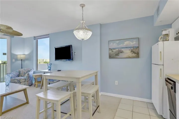 Dining area with baseboards and a chandelier