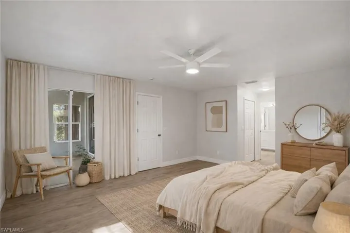 Bedroom featuring ceiling fan, light wood finished floors, a closet, and access to outside